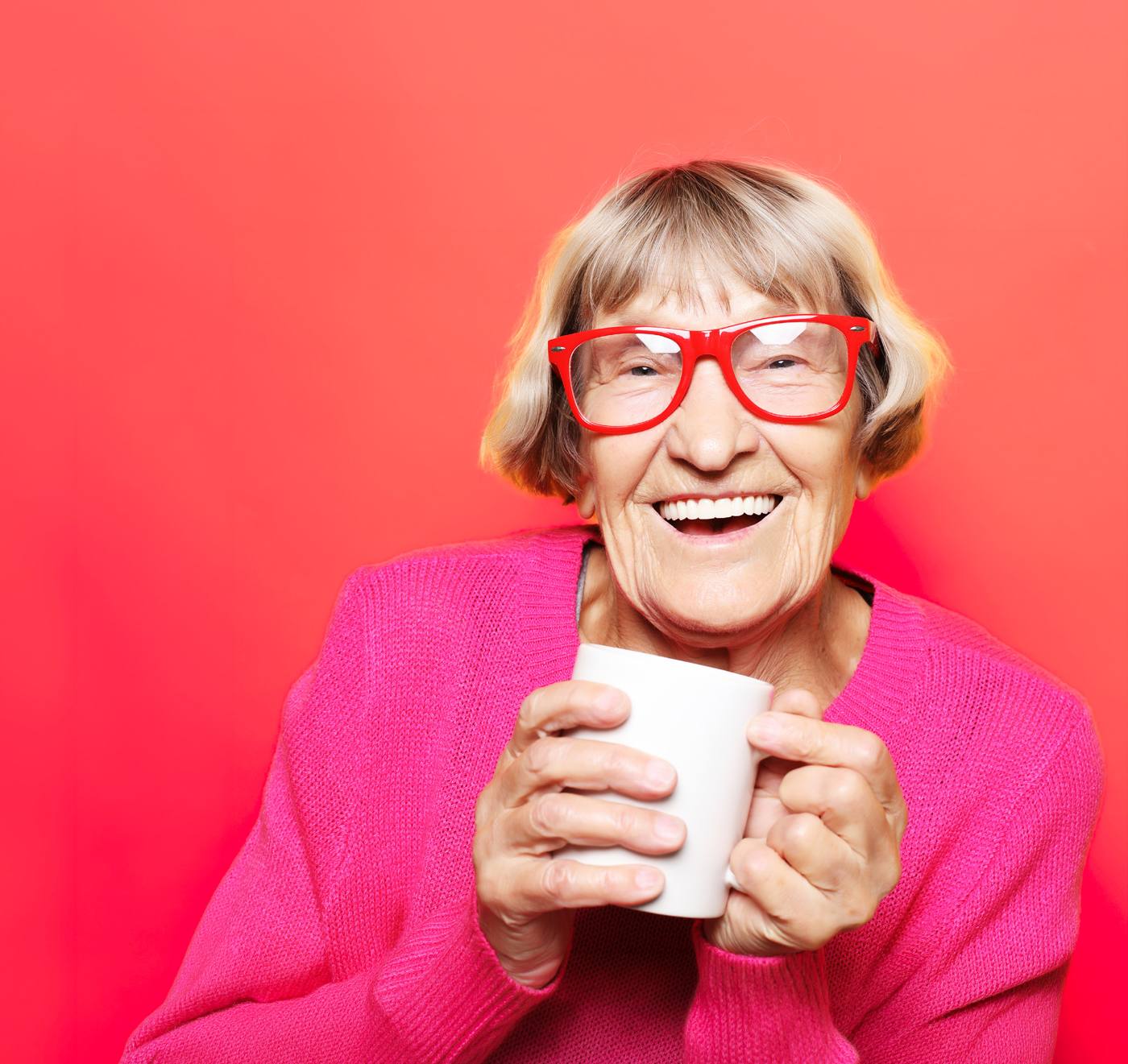 Smiling older woman holding a mug of tea